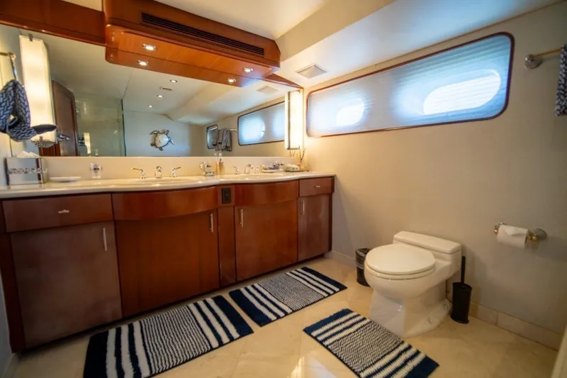 Slide: The Image of Luxurious yacht bathroom with wooden cabinetry, dual sinks, and nautical-themed decor, 1984 Lloyds Ships Tri-Deck. - 43