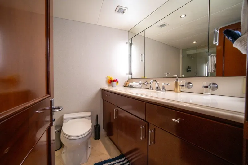 Slide: The Image of Luxurious bathroom on 1984 Lloyds Ships Tri-Deck yacht with elegant wood cabinetry and large mirror. - 47