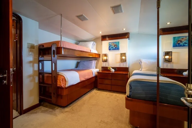Slide: The Image of Luxurious 1984 Lloyds Ships Tri-Deck yacht cabin with bunk beds and elegant decor. - 49