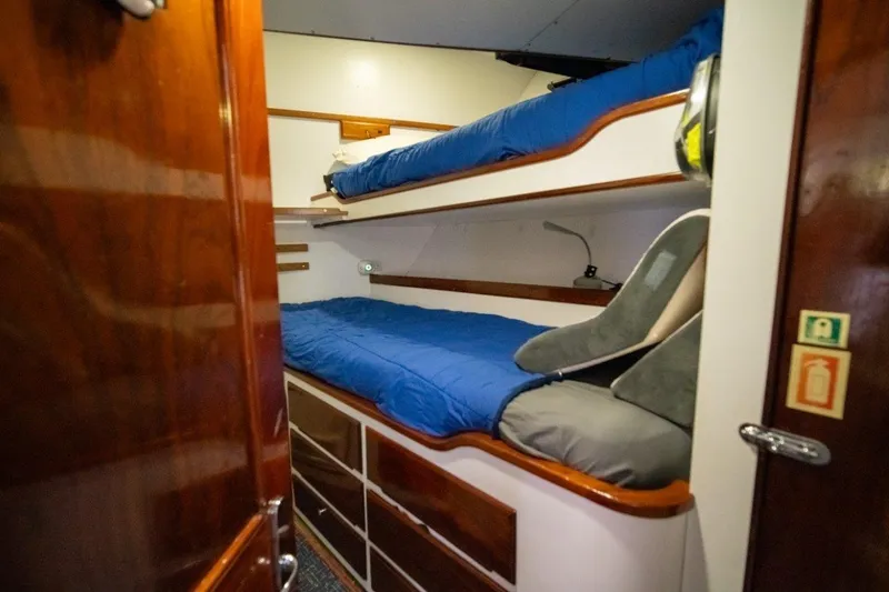 Slide: The Image of Cozy bunk bed cabin in 1984 Lloyds Ships Tri-Deck yacht with wooden accents. - 54