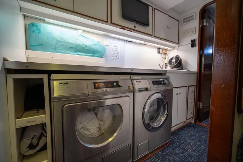 Slide: The Image of Laundry room on 1984 Lloyds Ships Tri-Deck yacht with Miele appliances and storage cabinets. - 55