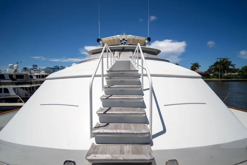 Slide: The Image of 1984 Lloyds Ships Tri-Deck yacht with wooden steps, docked under clear blue sky. - 6