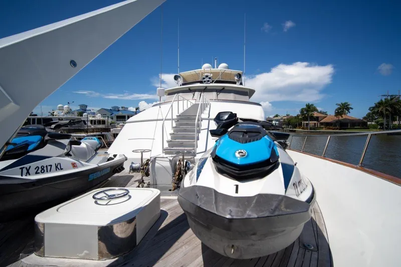 Slide: The Image of Luxury 1984 Lloyds Ships Tri-Deck yacht with jet skis on deck, docked by waterfront homes. - 7