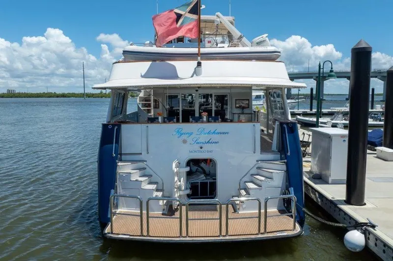 Slide: The Image of Luxury 1984 Lloyds Ships Tri-Deck yacht docked at marina under clear blue sky. - 8