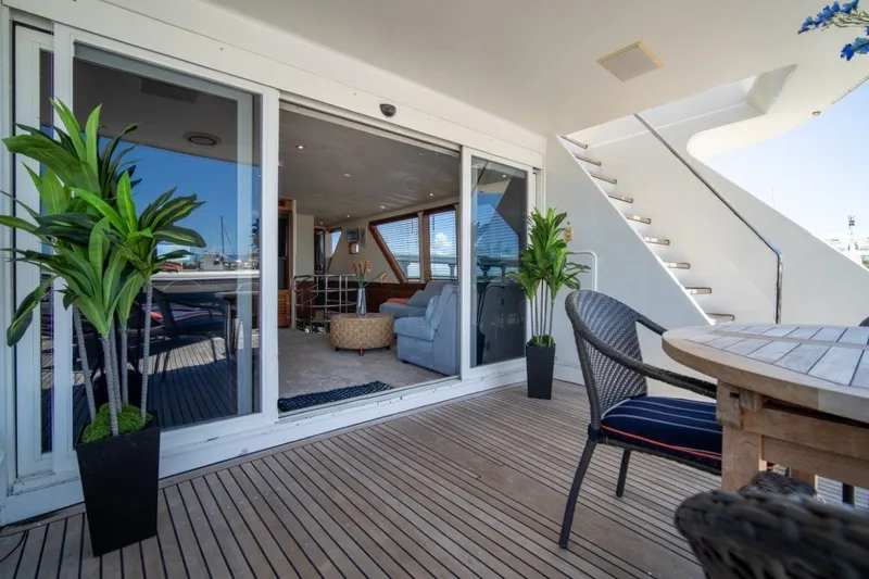 Slide: The Image of Luxurious 1984 Lloyds Ships Tri-Deck yacht interior with elegant seating and outdoor dining area. - 9