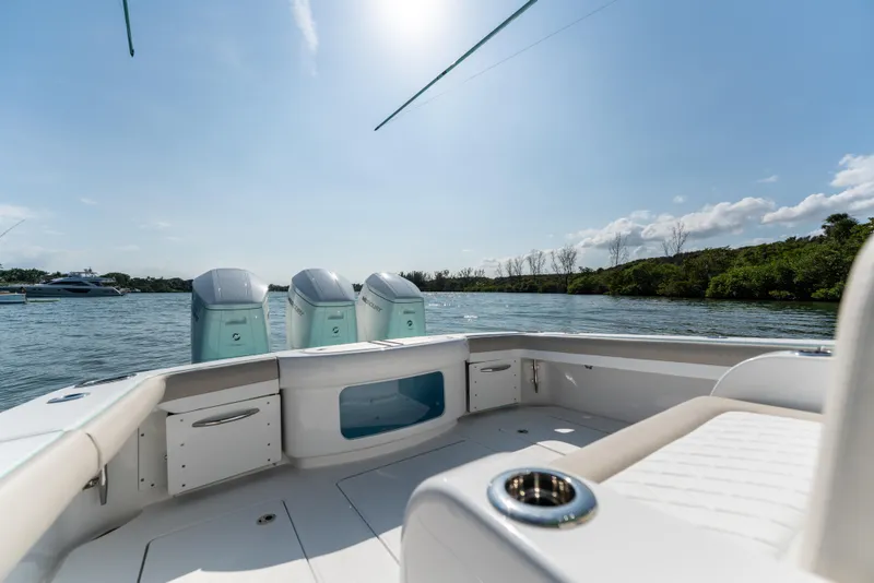 Slide: The Image of 2025 Mag Bay 43 CC boat with triple outboard engines on a sunny day. - 19