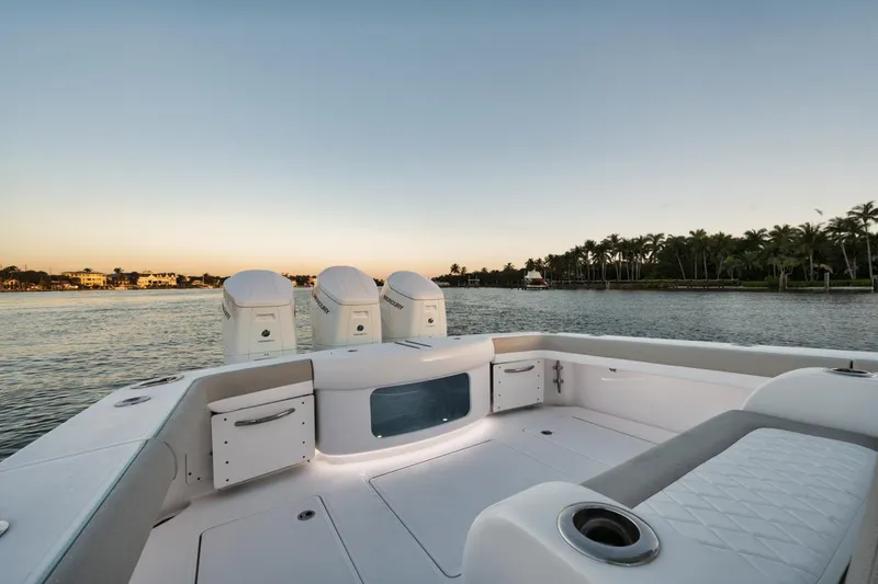 Slide: The Image of Mag Bay 43 CC 2025 boat with triple outboard engines on calm water. - 20