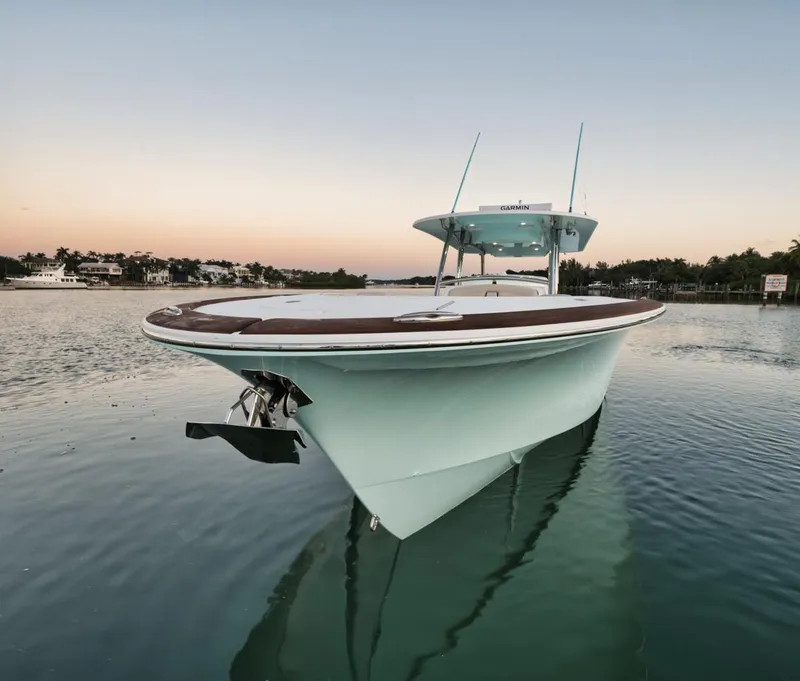 Slide: The Image of 2025 Mag Bay 43 CC boat on calm water at sunset. - 7