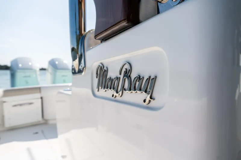 Slide: The Image of Close-up of 2025 Mag Bay 43 CC boat logo on white surface. - 8