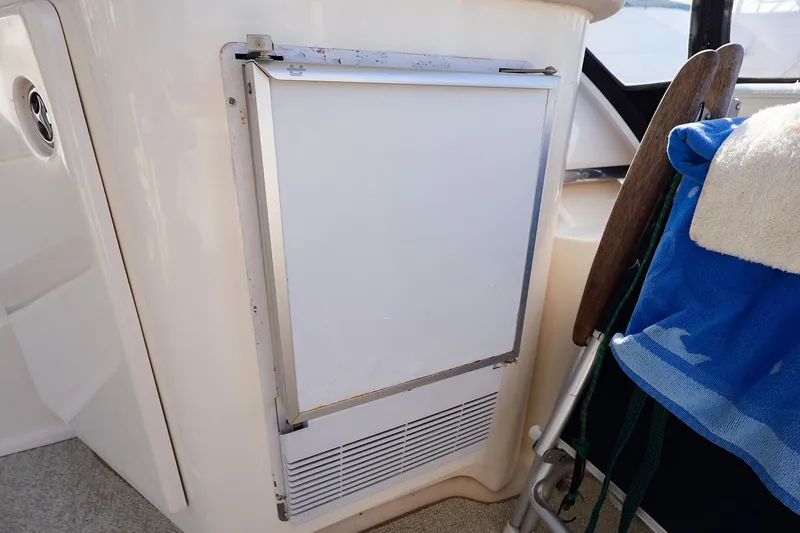 Slide: The Image of 2002 Silverton 43 Motor Yacht interior with built-in refrigerator and seating area. - 12