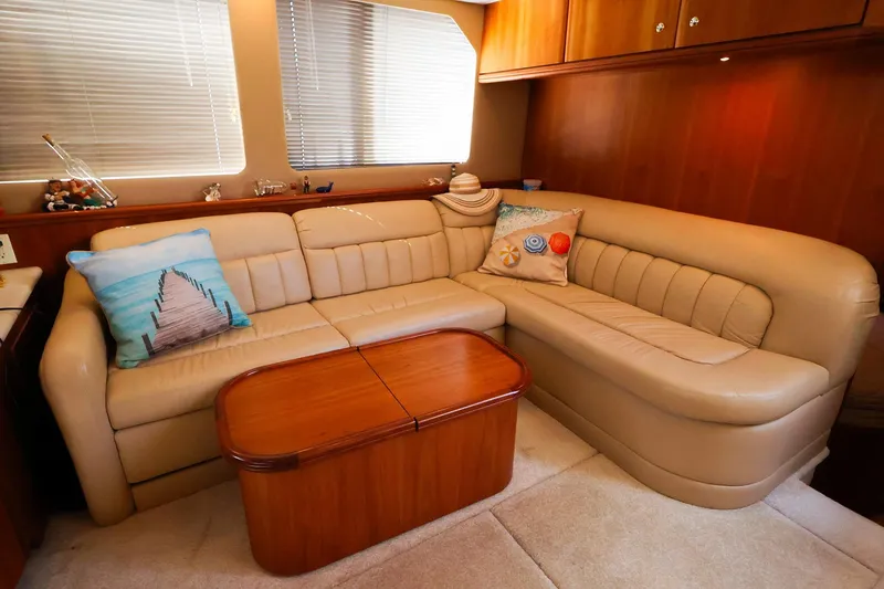Slide: The Image of Luxurious interior of 2002 Silverton 43 Motor Yacht with beige leather seating and decorative pillows. - 17