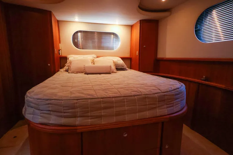 Slide: The Image of Luxurious bedroom interior of 2002 Silverton 43 Motor Yacht with cozy bed and wooden accents. - 19