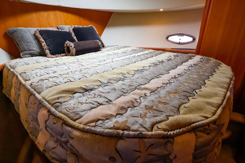 Slide: The Image of Luxurious bedroom interior of 2002 Silverton 43 Motor Yacht with plush bedding. - 20