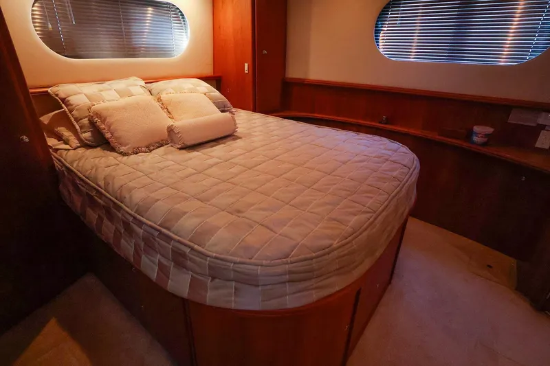 Slide: The Image of Luxurious bedroom interior of 2002 Silverton 43 Motor Yacht with cozy bedding. - 21