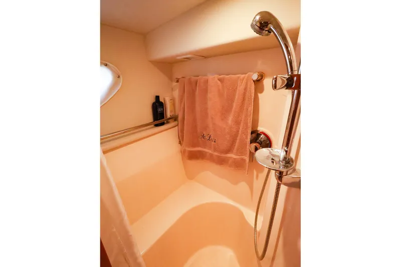 Slide: The Image of Shower area in 2002 Silverton 43 Motor Yacht with towel and toiletries. - 23