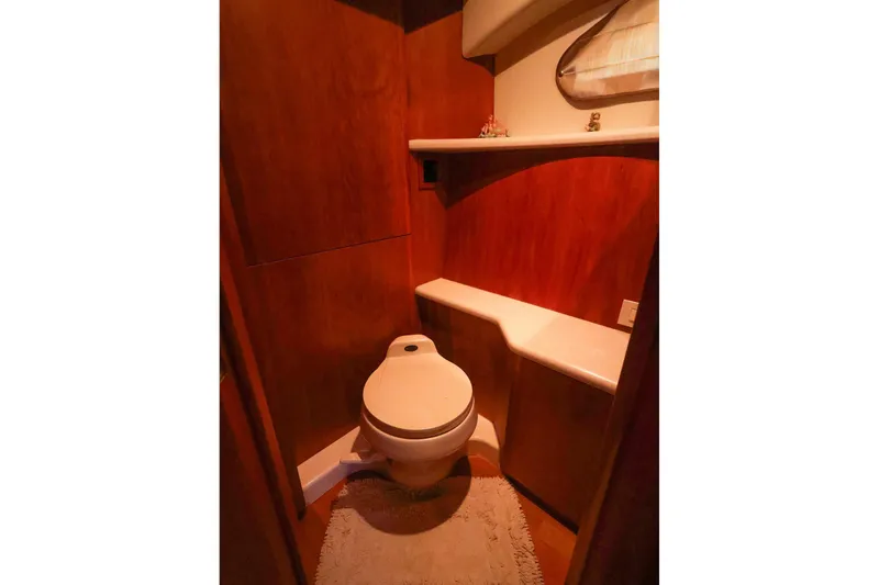 Slide: The Image of Bathroom interior of 2002 Silverton 43 Motor Yacht with wooden paneling and modern fixtures. - 25