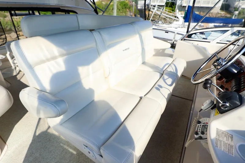 Slide: The Image of Luxurious seating on 2002 Silverton 43 Motor Yacht with steering wheel and controls. - 6