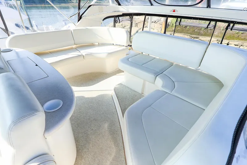 Slide: The Image of Luxurious interior of 2002 Silverton 43 Motor Yacht with plush seating and panoramic windows. - 9