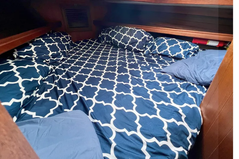 Slide: The Image of Cozy cabin bed with patterned bedding in 1981 Shannon 38 Ketch sailboat. - 3