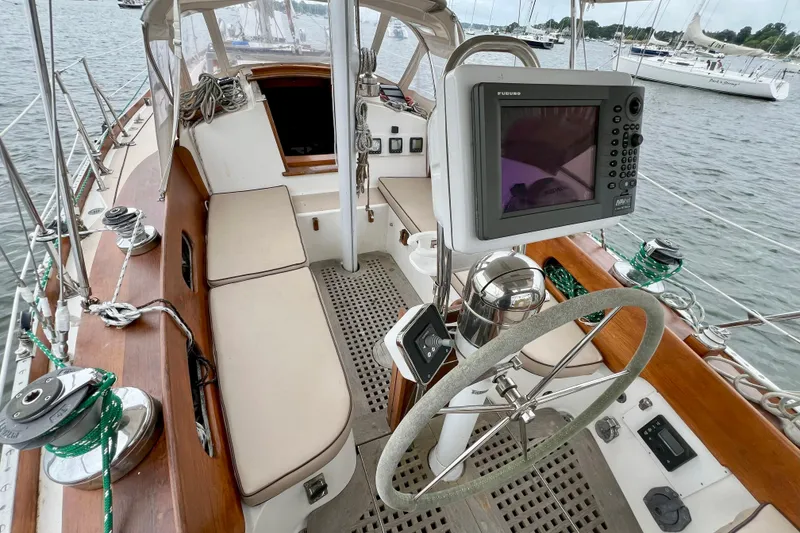 Slide: The Image of 1981 Shannon 38 Ketch sailboat cockpit with navigation equipment and wooden accents. - 6
