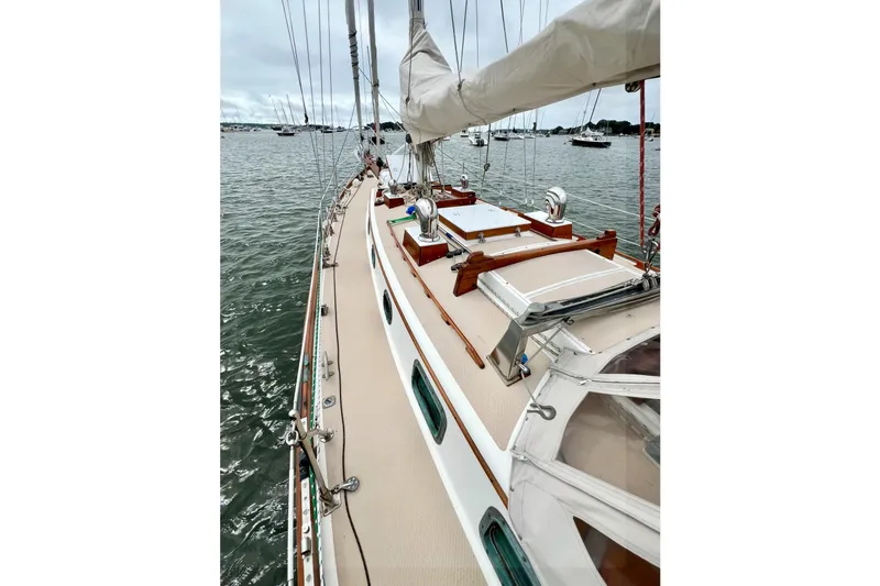 Slide: The Image of 1981 Shannon 38 Ketch sailboat on calm waters, showcasing deck and rigging. - 7