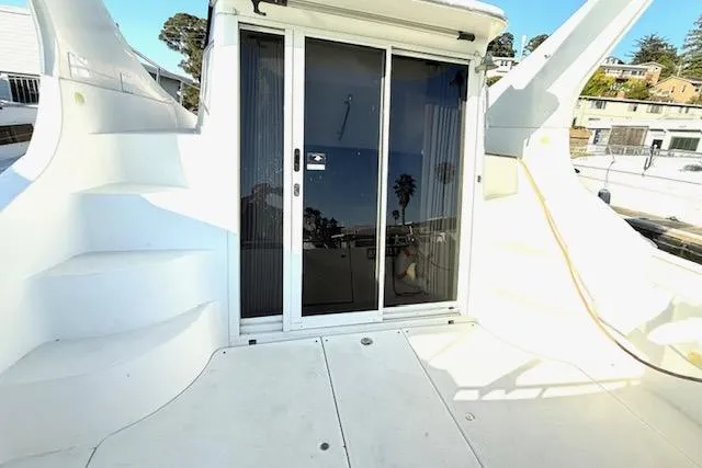 Slide: The Image of 2007 Carver 36 Mariner yacht deck with sliding glass doors and steps. - 13