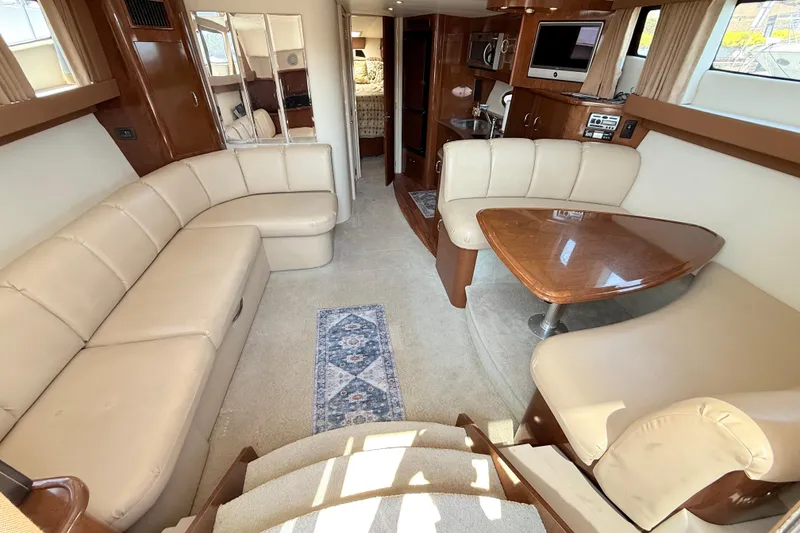 Slide: The Image of Luxurious interior of 2007 Carver 36 Mariner yacht with plush seating and elegant wood finishes. - 16