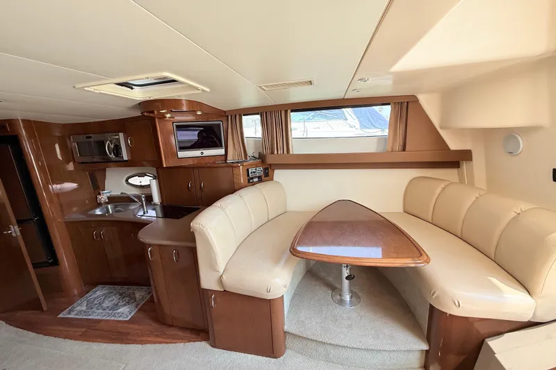 Slide: The Image of Luxurious interior of 2007 Carver 36 Mariner yacht with kitchen and dining area. - 18