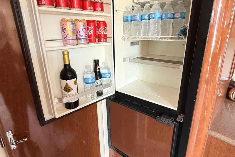 Slide: The Image of Fridge inside 2007 Carver 36 Mariner yacht, stocked with drinks and water bottles. - 20