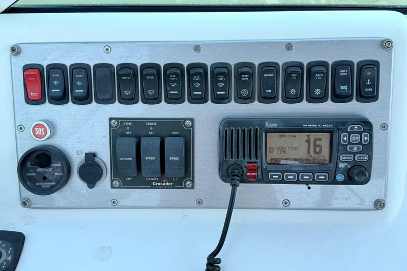 Slide: The Image of Control panel of a 2007 Carver 36 Mariner with switches and marine radio. - 8