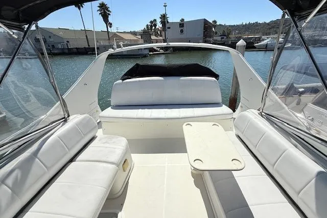 Slide: The Image of 2007 Carver 36 Mariner yacht interior with white seating and table, docked in marina. - 11