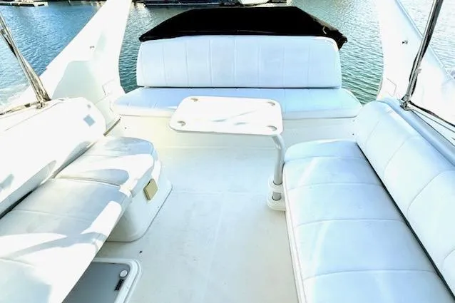 Slide: The Image of 2007 Carver 36 Mariner yacht interior with white seating and table, overlooking water. - 12