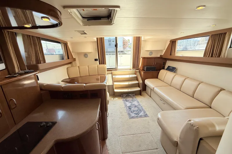 Slide: The Image of Luxurious interior of 2007 Carver 36 Mariner yacht with beige seating and elegant wood finishes. - 17