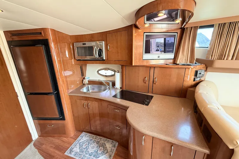 Slide: The Image of Interior of 2007 Carver 36 Mariner yacht with kitchen and entertainment area. - 19