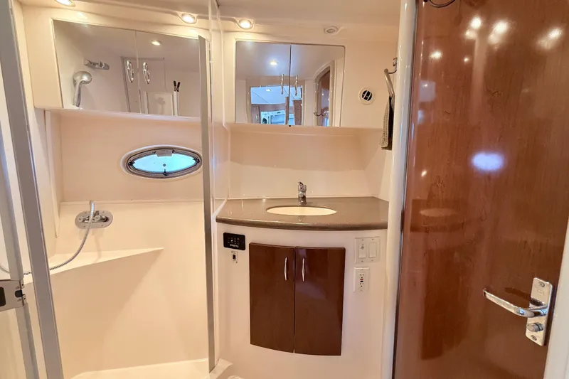 Slide: The Image of 2007 Carver 36 Mariner bathroom with sink, shower, and wooden cabinetry. - 26