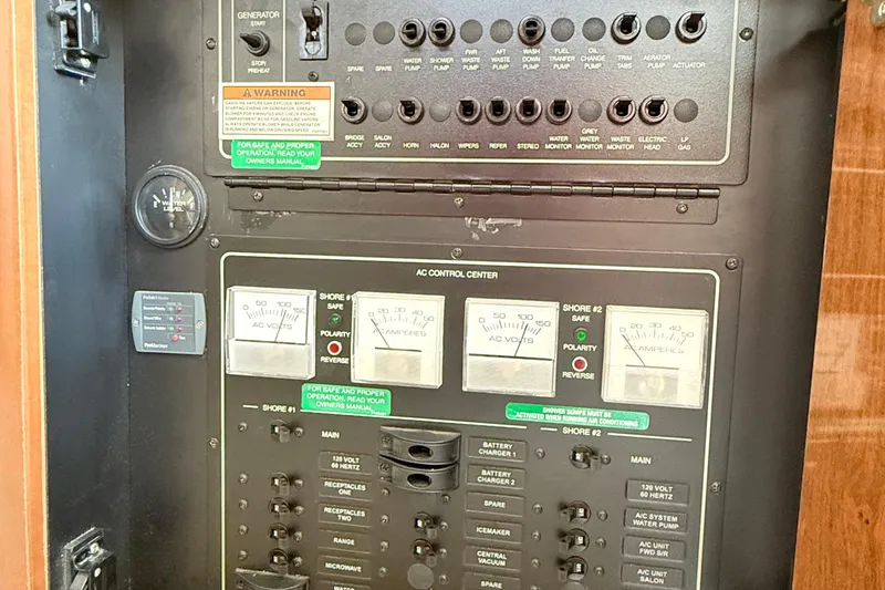 Slide: The Image of Electrical control panel of a 2007 Carver 36 Mariner boat, featuring various switches and gauges. - 28