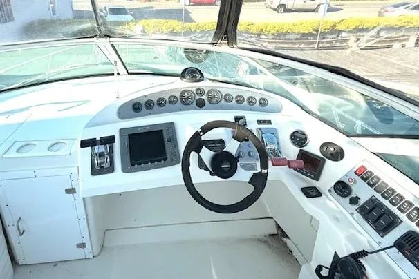 Slide: The Image of 2007 Carver 36 Mariner helm with steering wheel, gauges, and navigation controls. - 4