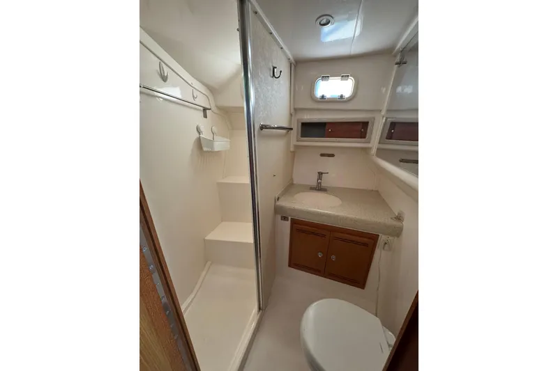 Slide: The Image of 2008 Cabo 35 Flybridge bathroom with shower, sink, and storage cabinets. - 14