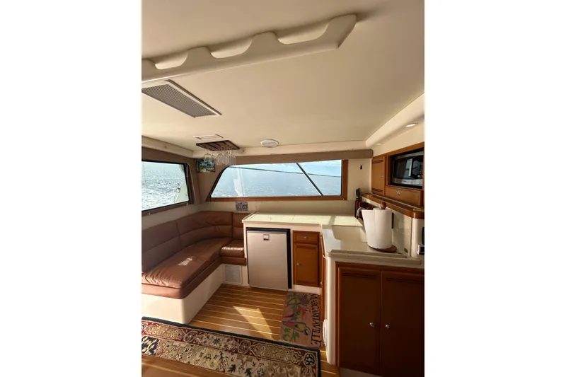 Slide: The Image of Interior of 2008 Cabo 35 Flybridge yacht with seating and kitchenette. - 15