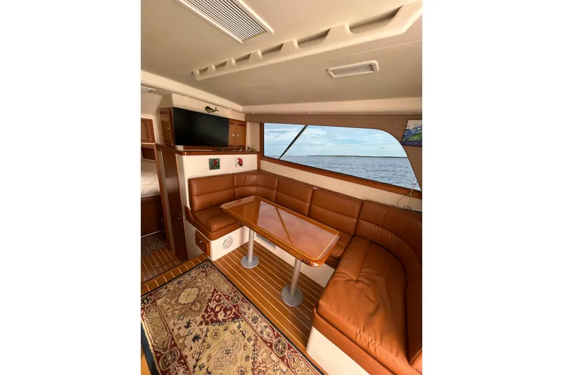 Slide: The Image of Interior of 2008 Cabo 35 Flybridge yacht with leather seating and ocean view. - 16