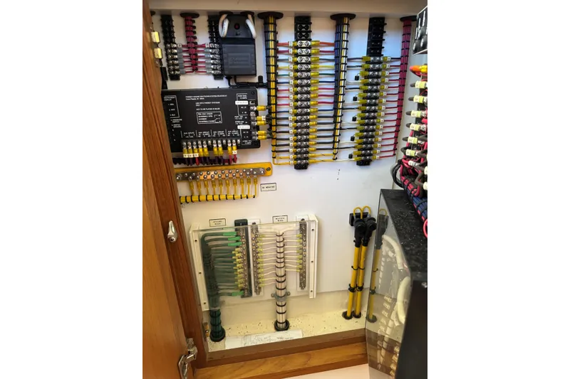 Slide: The Image of Electrical panel of 2008 Cabo 35 Flybridge boat with organized wiring and components. - 18