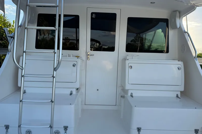 Slide: The Image of 2008 Cabo 35 Flybridge boat with ladder and storage compartments on deck. - 2