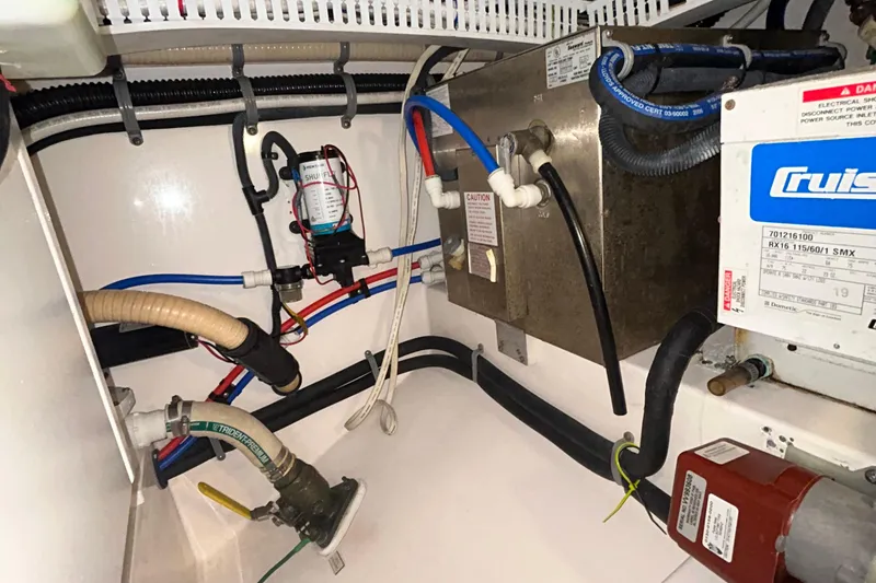 Slide: The Image of Engine room of 2008 Cabo Yachts Sportfish 35, showcasing plumbing and electrical systems. - 21