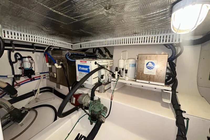 Slide: The Image of Engine room of 2008 Cabo Yachts Sportfish 35, showcasing mechanical components and wiring. - 27