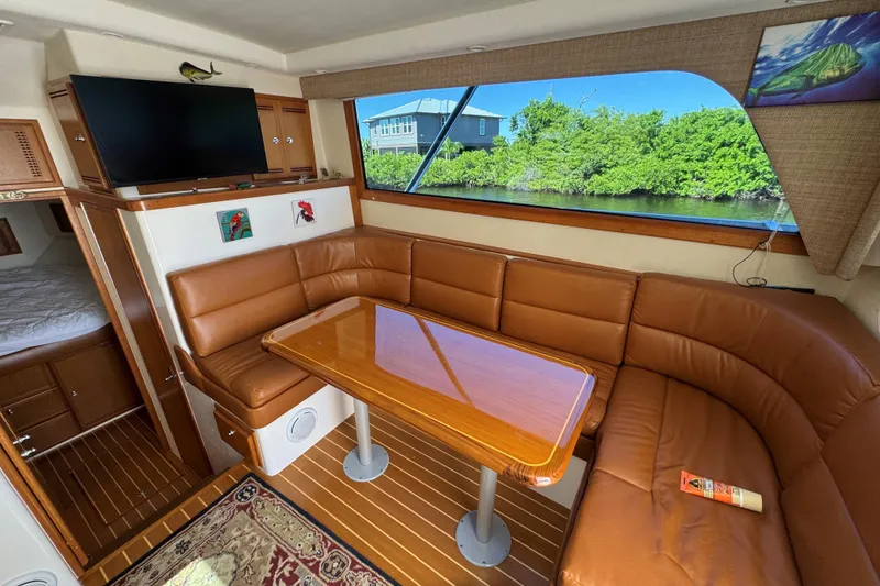 Slide: The Image of Luxurious interior of 2008 Cabo 35 Flybridge with leather seating and scenic window view. - 28