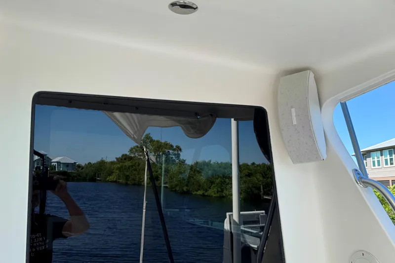 Slide: The Image of 2008 Cabo 35 Flybridge interior with window view of water and shoreline. - 34