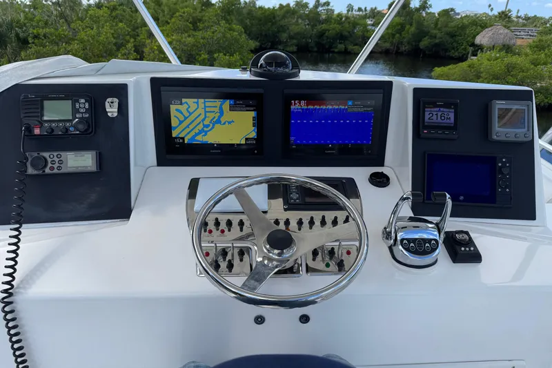 Slide: The Image of Helm of 2008 Cabo 35 Flybridge with navigation and control systems. - 7