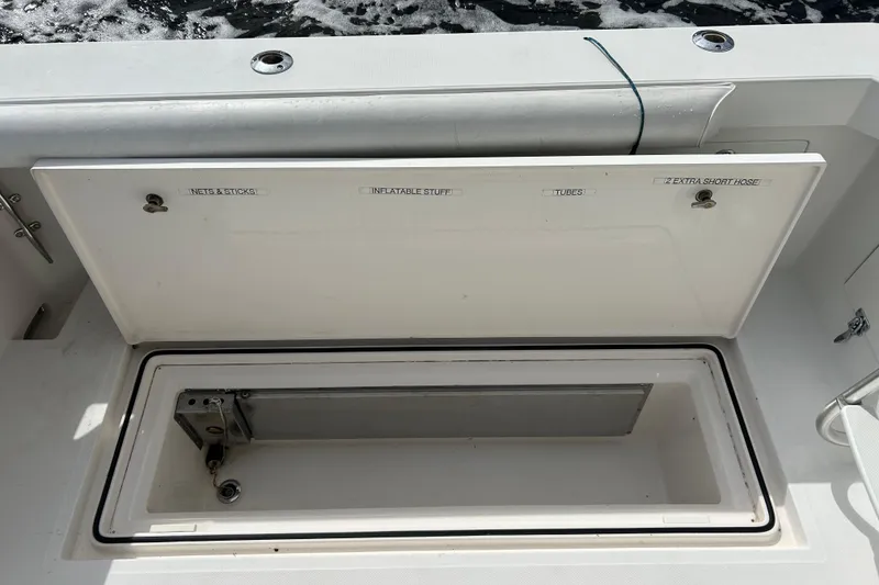 Slide: The Image of Open storage compartment on 2008 Cabo Yachts Sportfish 35, labeled for various equipment. - 8