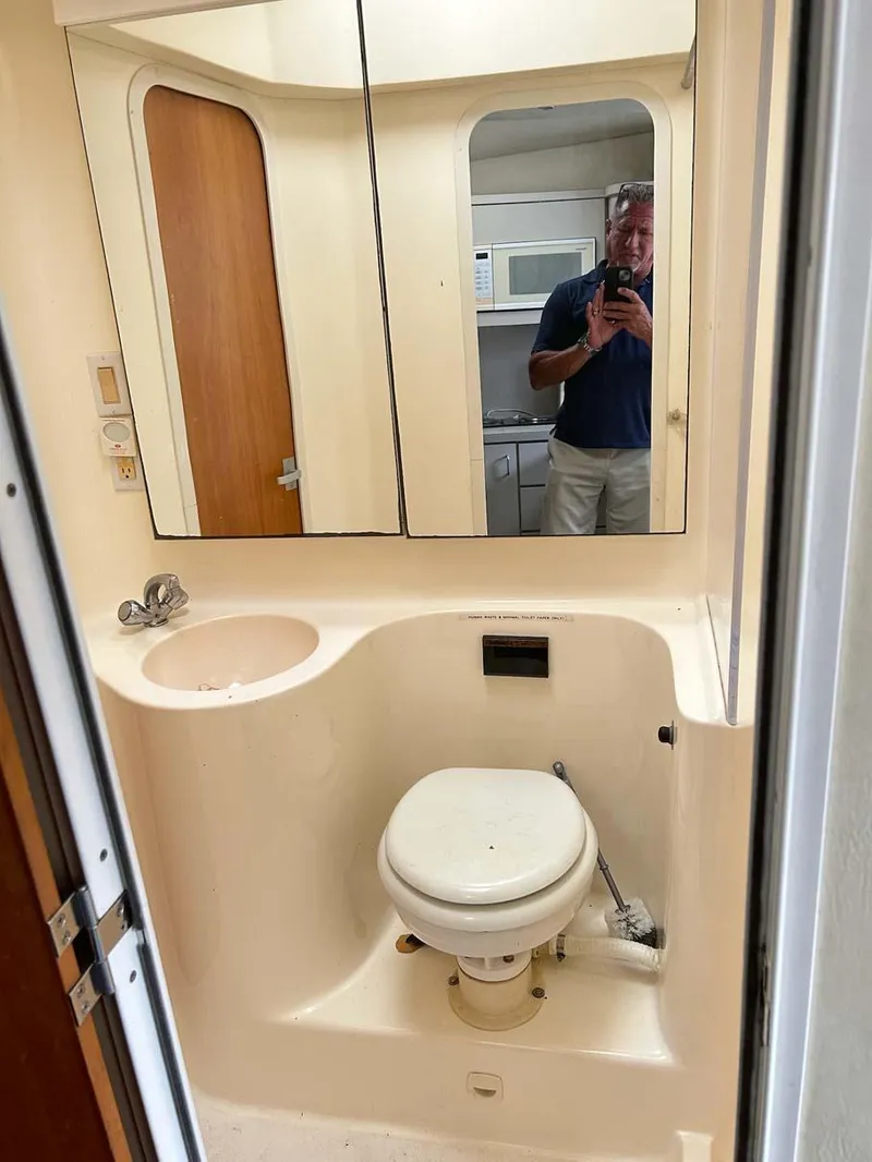 Slide: The Image of Bathroom interior of 1993 Mainship 36 Express yacht with mirror and toilet. - 11