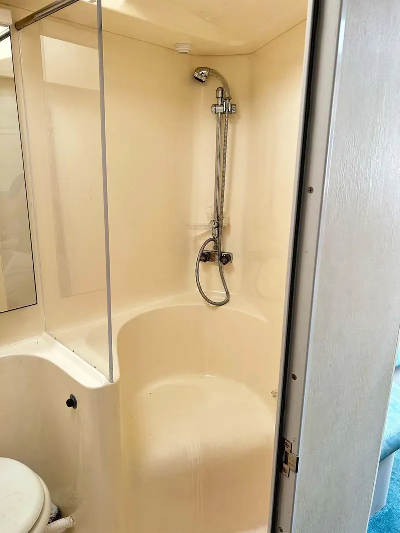 Slide: The Image of Shower area in 1993 Mainship 36 Express boat, featuring a compact design. - 12